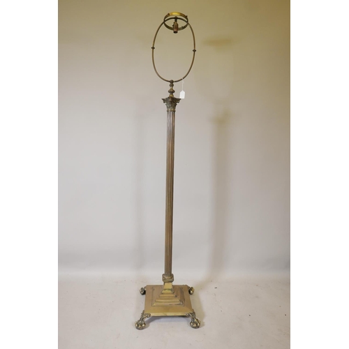 1225 - A Corinthian column standard lamp with stepped platform base and paw feet, 68