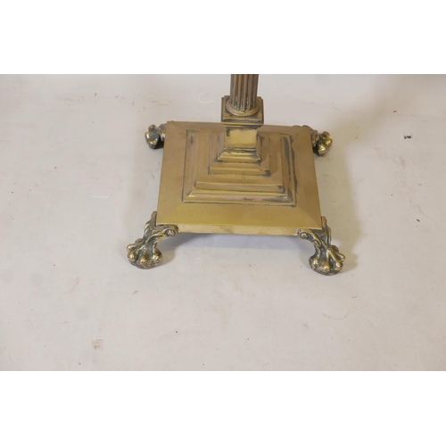 1225 - A Corinthian column standard lamp with stepped platform base and paw feet, 68