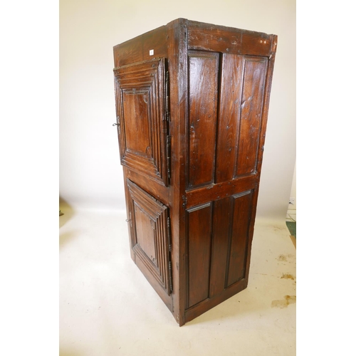 1227 - A French oak cupboard with two doors and panelled sides, late C17th/early C18th, 31