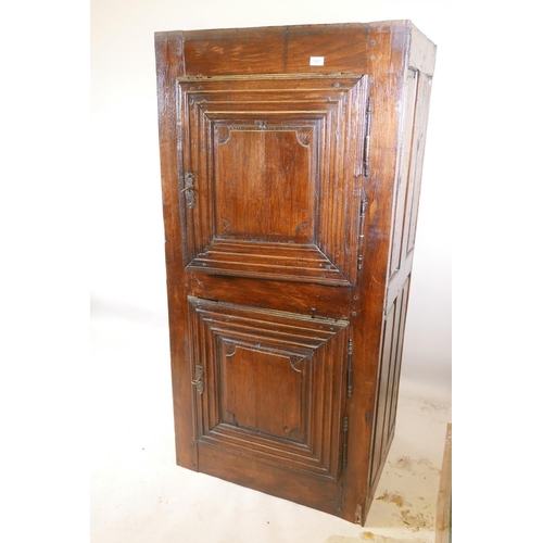 1227 - A French oak cupboard with two doors and panelled sides, late C17th/early C18th, 31