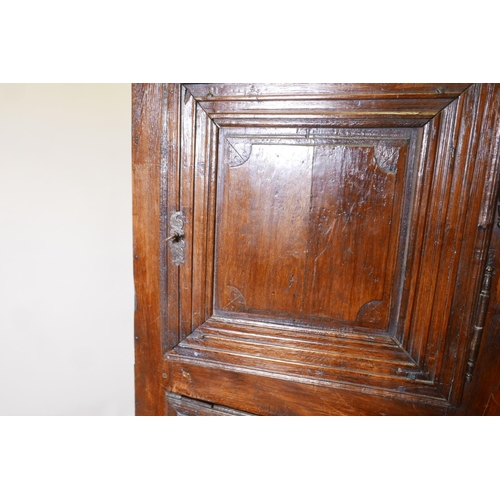 1227 - A French oak cupboard with two doors and panelled sides, late C17th/early C18th, 31