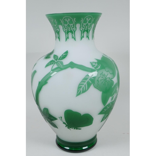 14 - A good Peking glass vase with cut green overlay over white, depicting butterflies and flowering bran... 