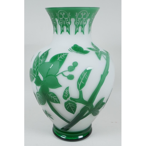 14 - A good Peking glass vase with cut green overlay over white, depicting butterflies and flowering bran... 