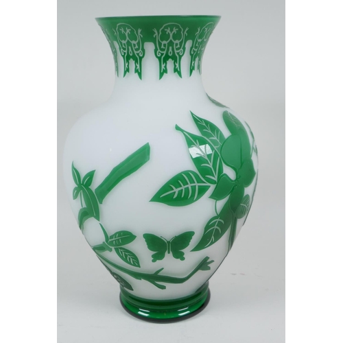 14 - A good Peking glass vase with cut green overlay over white, depicting butterflies and flowering bran... 