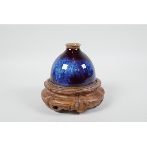 18 - A Chinese porcelain water pot with a Jun ware flambe glaze, on a carved hardwood stand, 5