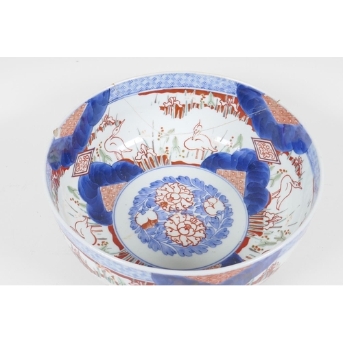 21 - A C19th Japanese Imari porcelain bowl painted with herons amongst the reeds, in traditional colours,... 