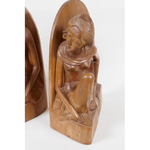 26 - A pair of Balinese hardwood bookends carved as male and female figures, 8