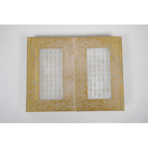 36 - A Chinese wood and material bound book containing white jade tablets with engraved and gilt characte... 