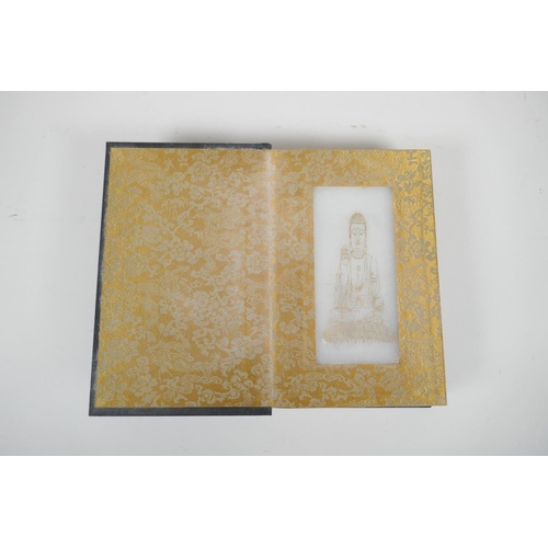 36 - A Chinese wood and material bound book containing white jade tablets with engraved and gilt characte... 