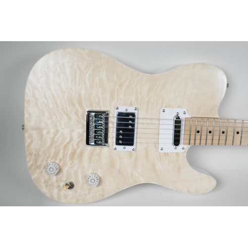 4 - An electric guitar in the style of a Fender with blonde maple veneered body, the head bears label Ge... 