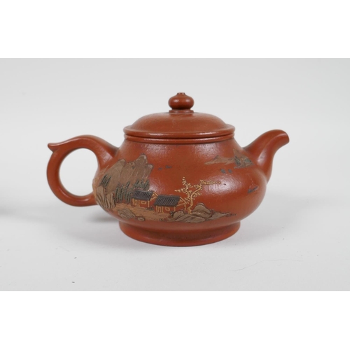 58 - A Chinese Yixing teapot with raised and painted landscape decoration, and another with enamelled pea... 