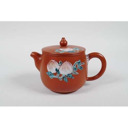 58 - A Chinese Yixing teapot with raised and painted landscape decoration, and another with enamelled pea... 