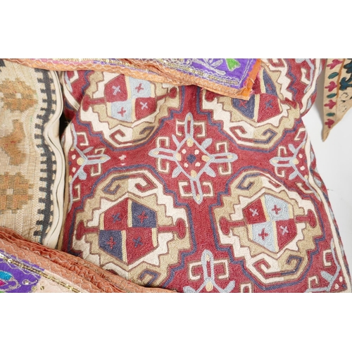 64 - A Vintage Uzbekistan suzani embroidered door drape, an Indian pelmet, two Uzbekistan suzani embroide... 