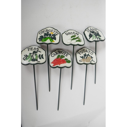 66 - A set of six painted cast metal vegetable markers, 4¼