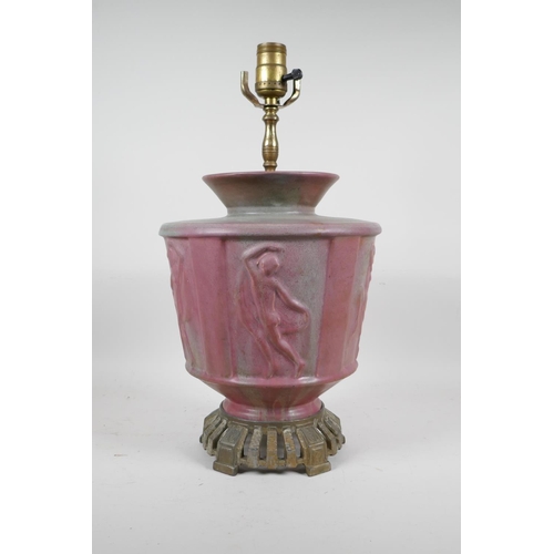 69 - A pink glazed ceramic lamp with metal mounts, the body decorated with classical nudes, 17