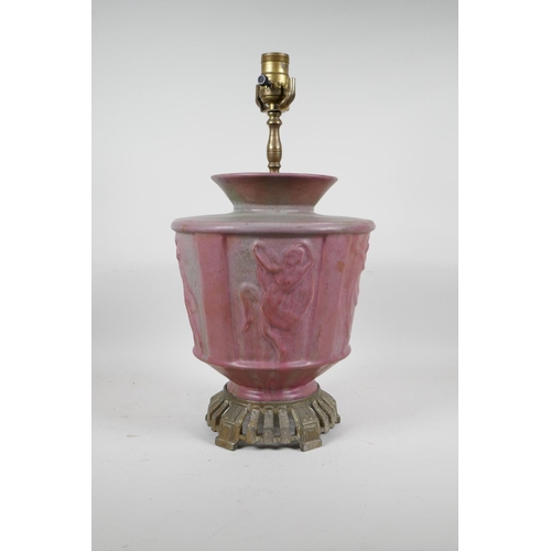 69 - A pink glazed ceramic lamp with metal mounts, the body decorated with classical nudes, 17