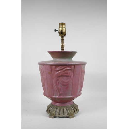 69 - A pink glazed ceramic lamp with metal mounts, the body decorated with classical nudes, 17