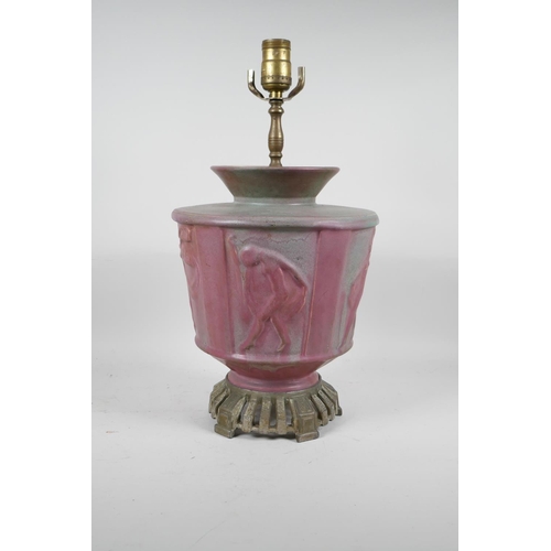 69 - A pink glazed ceramic lamp with metal mounts, the body decorated with classical nudes, 17