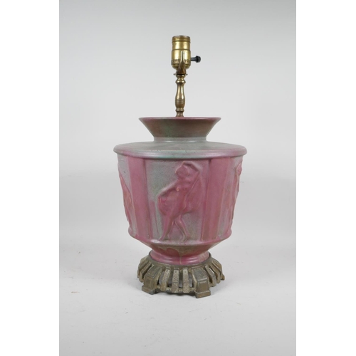 69 - A pink glazed ceramic lamp with metal mounts, the body decorated with classical nudes, 17