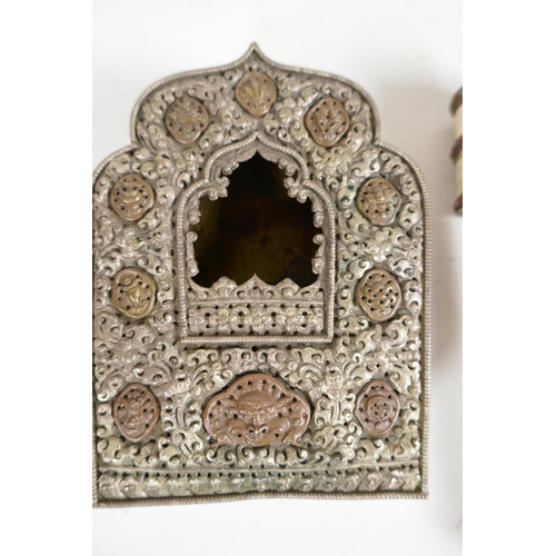 79 - A Tibetan copper and embossed white metal shrine, 5½