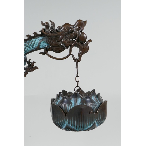 85 - An Oriental hardwood and bronze incense burner of dragon and lotus flower form, 12