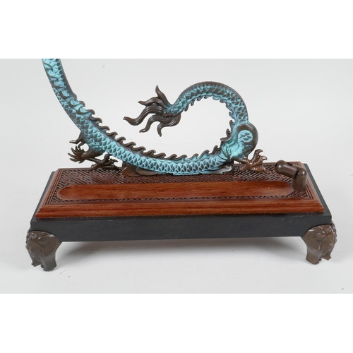 85 - An Oriental hardwood and bronze incense burner of dragon and lotus flower form, 12