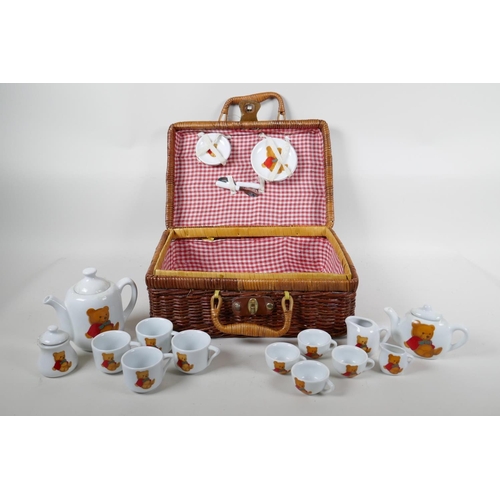 87 - A child's 'Teddy Bear's Picnic' hamper containing a porcelain part tea and coffee set, 12