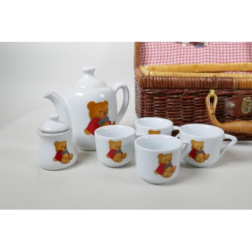 87 - A child's 'Teddy Bear's Picnic' hamper containing a porcelain part tea and coffee set, 12