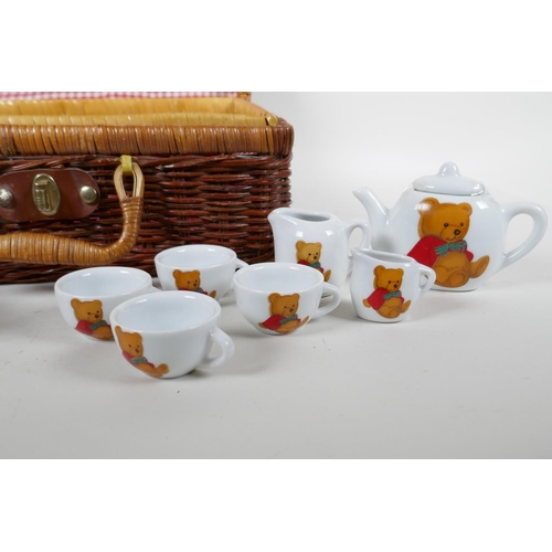 87 - A child's 'Teddy Bear's Picnic' hamper containing a porcelain part tea and coffee set, 12