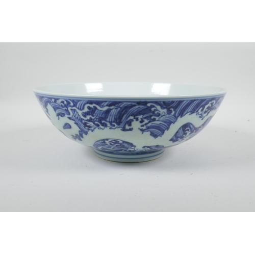 90 - A Chinese blue and white porcelain bowl with twin dragon decoration, 6 character mark to base, 10