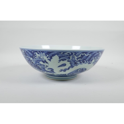 90 - A Chinese blue and white porcelain bowl with twin dragon decoration, 6 character mark to base, 10