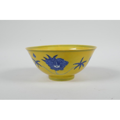 93 - A Chinese Ming style yellow ground porcelain rice bowl with blue and white floral decoration, 6 char... 