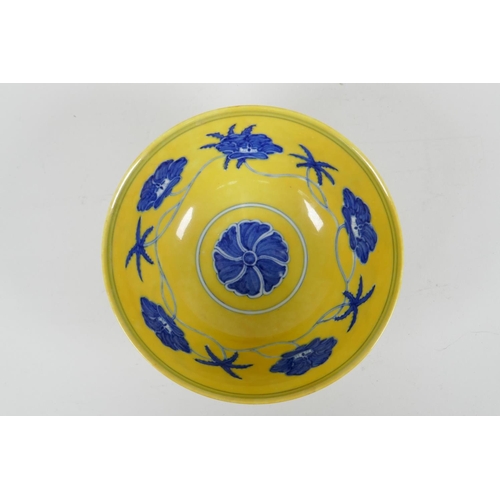 93 - A Chinese Ming style yellow ground porcelain rice bowl with blue and white floral decoration, 6 char... 