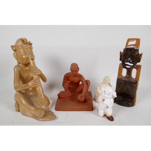 97 - Five figures including red earthenware man, composition Buddha, Hamnet pig figure, Balinese wood pip... 