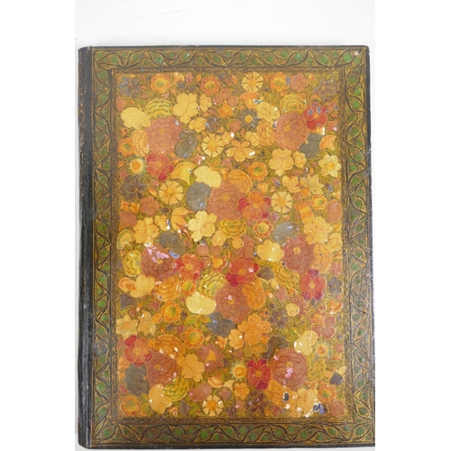 99 - A Kashmiri papier mache book cover profusely decorated with flowers, 9