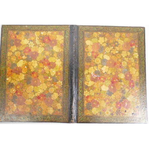 99 - A Kashmiri papier mache book cover profusely decorated with flowers, 9