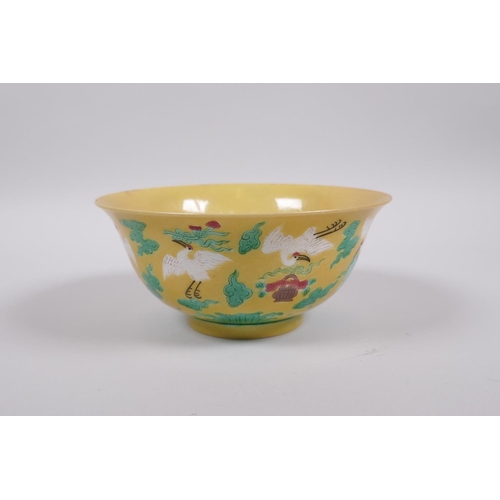 20 - A Chinese yellow ground porcelain rice bowl decorated with red crowned cranes in flight, 6 character... 