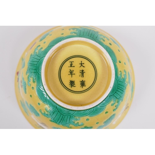 20 - A Chinese yellow ground porcelain rice bowl decorated with red crowned cranes in flight, 6 character... 