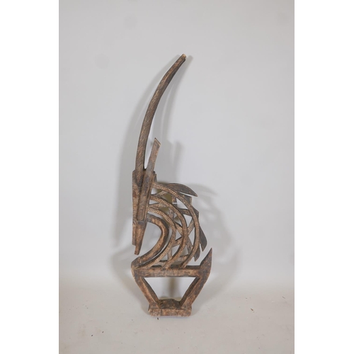 29 - An African carved wood stylised figure of a antelope, A/F, 44