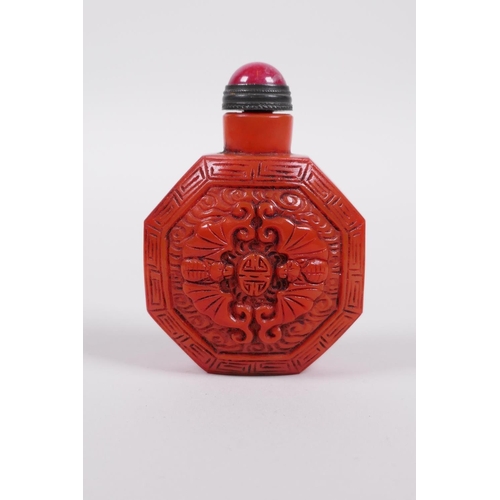 3 - A coral coloured Peking glass snuff bottle of octagonal form with moulded bat and auspicious symbol ... 