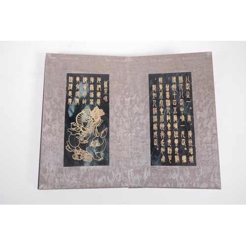 41 - A Chinese wood and silk bound book containing spinach jade tablets with engraved and gilt inscriptio... 