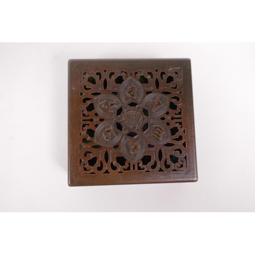 20 - A sino Tibetan bronze incense box and pierced cover, decorated with auspicious symbols, impressed se... 