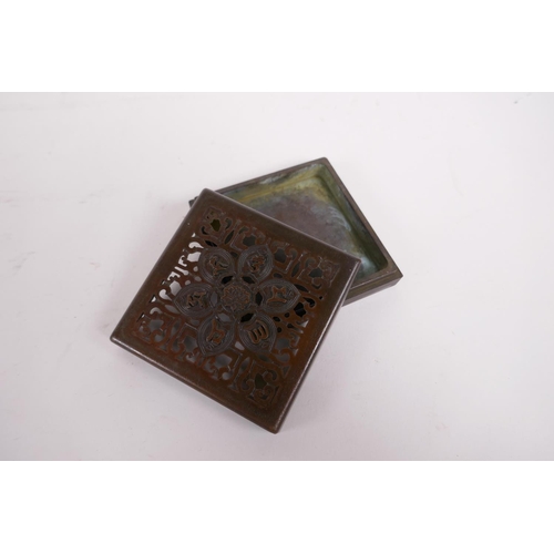 20 - A sino Tibetan bronze incense box and pierced cover, decorated with auspicious symbols, impressed se... 