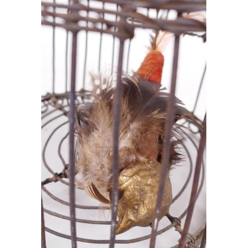 22 - A domed wire bird cage with woven banding, housing a model bird with metal head and feet, 11