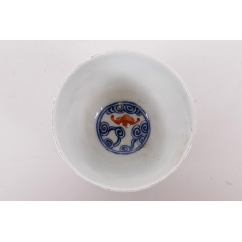 25 - A Chinese blue and white porcelain tea bowl with iron red bat decoration, Quing six character mark t... 