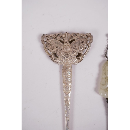 35 - A Chinese white metal hairpin with butterfly decoration, and another hairpin with a carved green jad... 