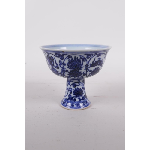 45 - A Ming style blue and white porcelain stem cup with lotus flower decoration, six character mark to b... 