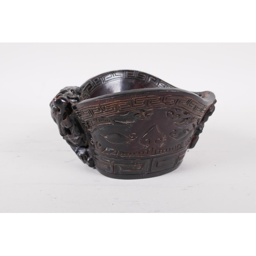 53 - A Chinese faux horn libation cup with carved kylin decoration, mark to base, 3