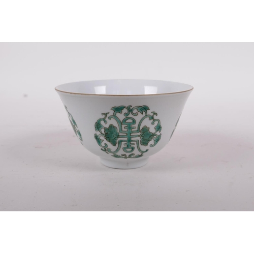 58 - An early C20th Chinese porcelain tea bowl decorated with green enamel longevity symbol, Daoguang sea... 