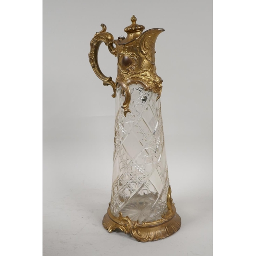 11 - A C19th gilt metal and cut glass claret jug, 12